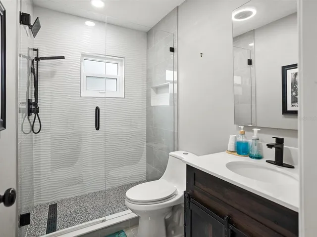 a bathroom with a sink toilet and shower