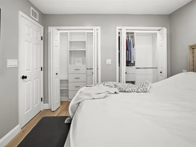 a bedroom with a bed and a walk in closet