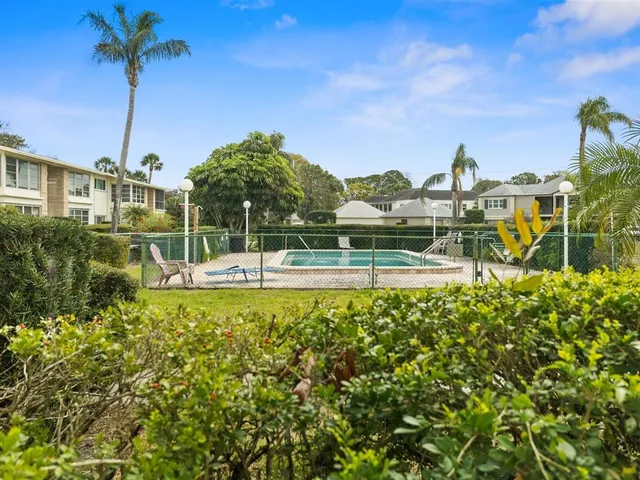 a view of a swimming pool with a table and chairs
