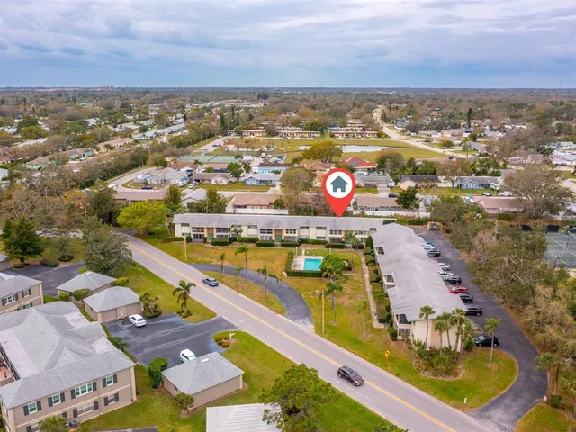 an aerial view of residential building and lake