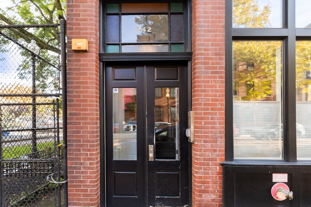 242 Shawmut Avenue, Unit 1B Boston, MA 02118 - Photo 13 of 16 a front view of a building with a glass door