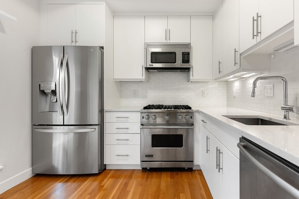 242 Shawmut Avenue, Unit 1B Boston, MA 02118 - Photo 4 of 16 a kitchen with stainless steel appliances a stove microwave and a refrigerator