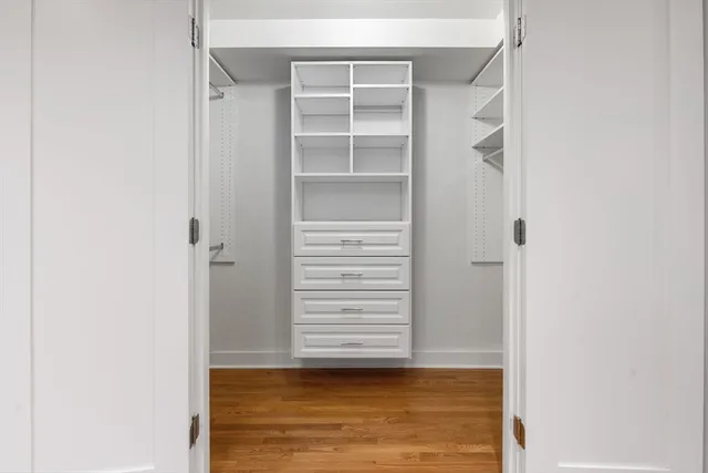 a view of walk in closet with empty racks