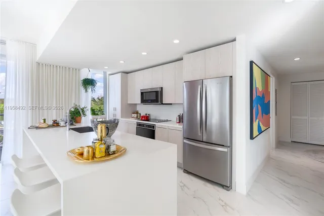 a kitchen with a refrigerator a stove and a sink
