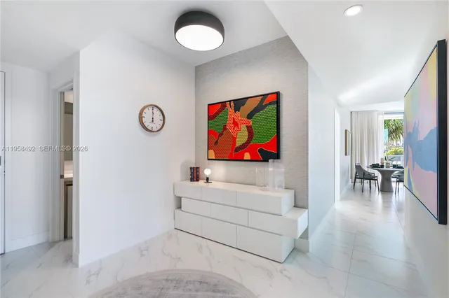 a living room with furniture and a wall painting