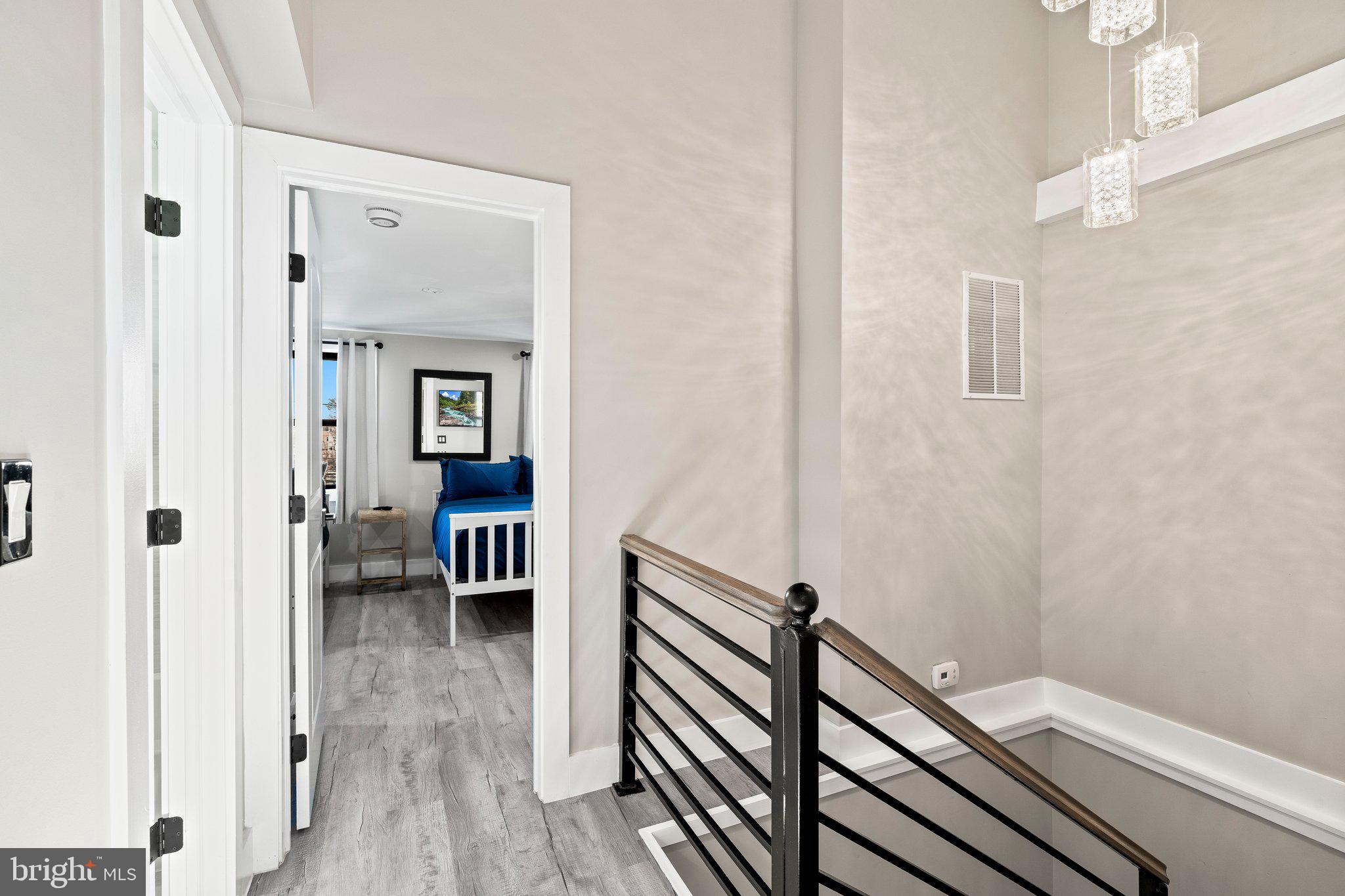 124 Master Street Philadelphia, PA 19122 - Photo 12 of 39 a view of a hallway with wooden floor and staircase