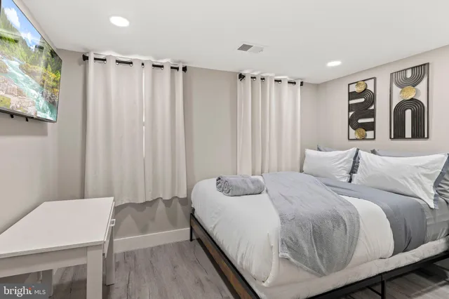 a spacious bedroom with a bed and a table