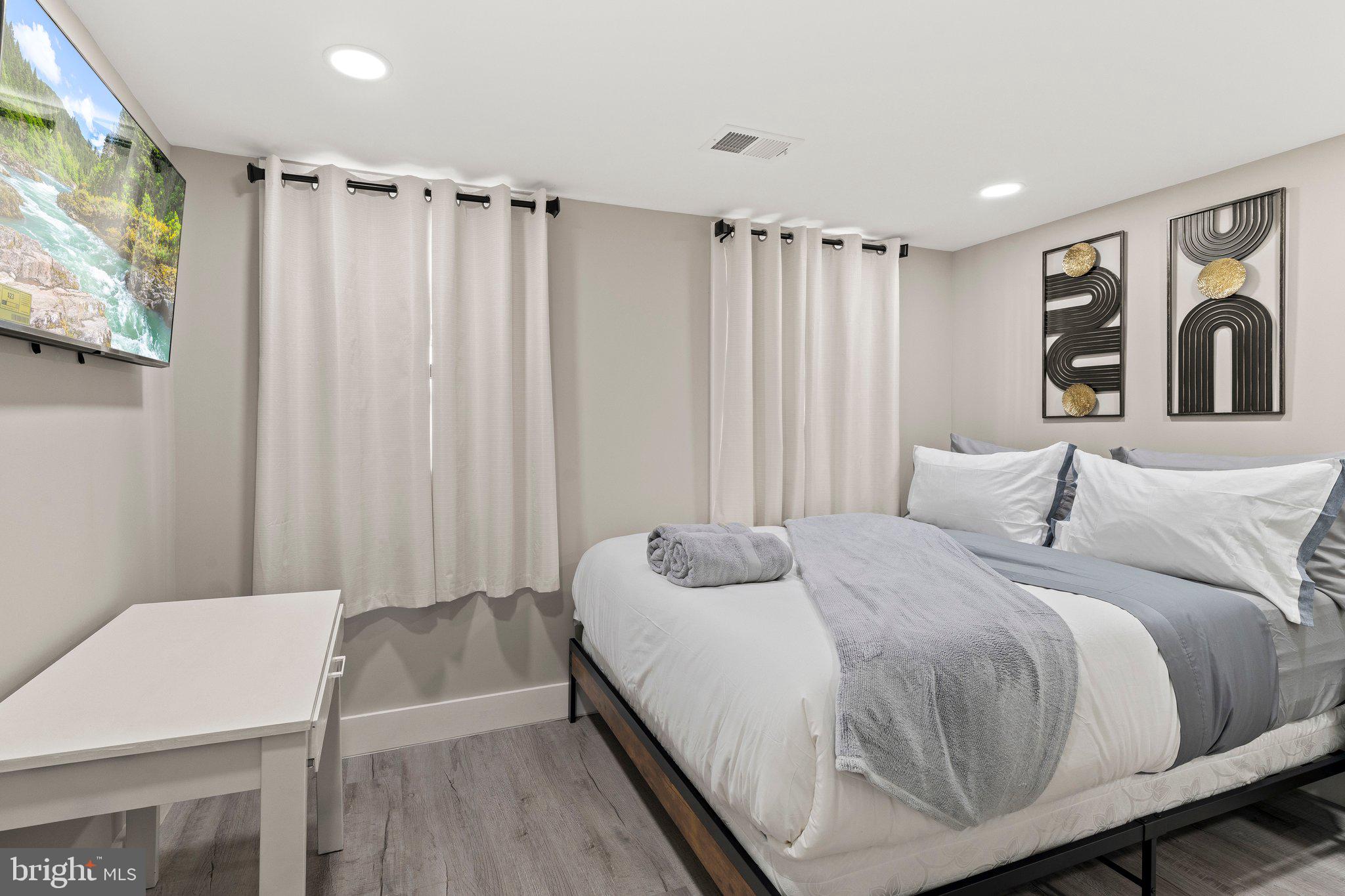 124 Master Street Philadelphia, PA 19122 - Photo 16 of 39 a spacious bedroom with a bed and a table