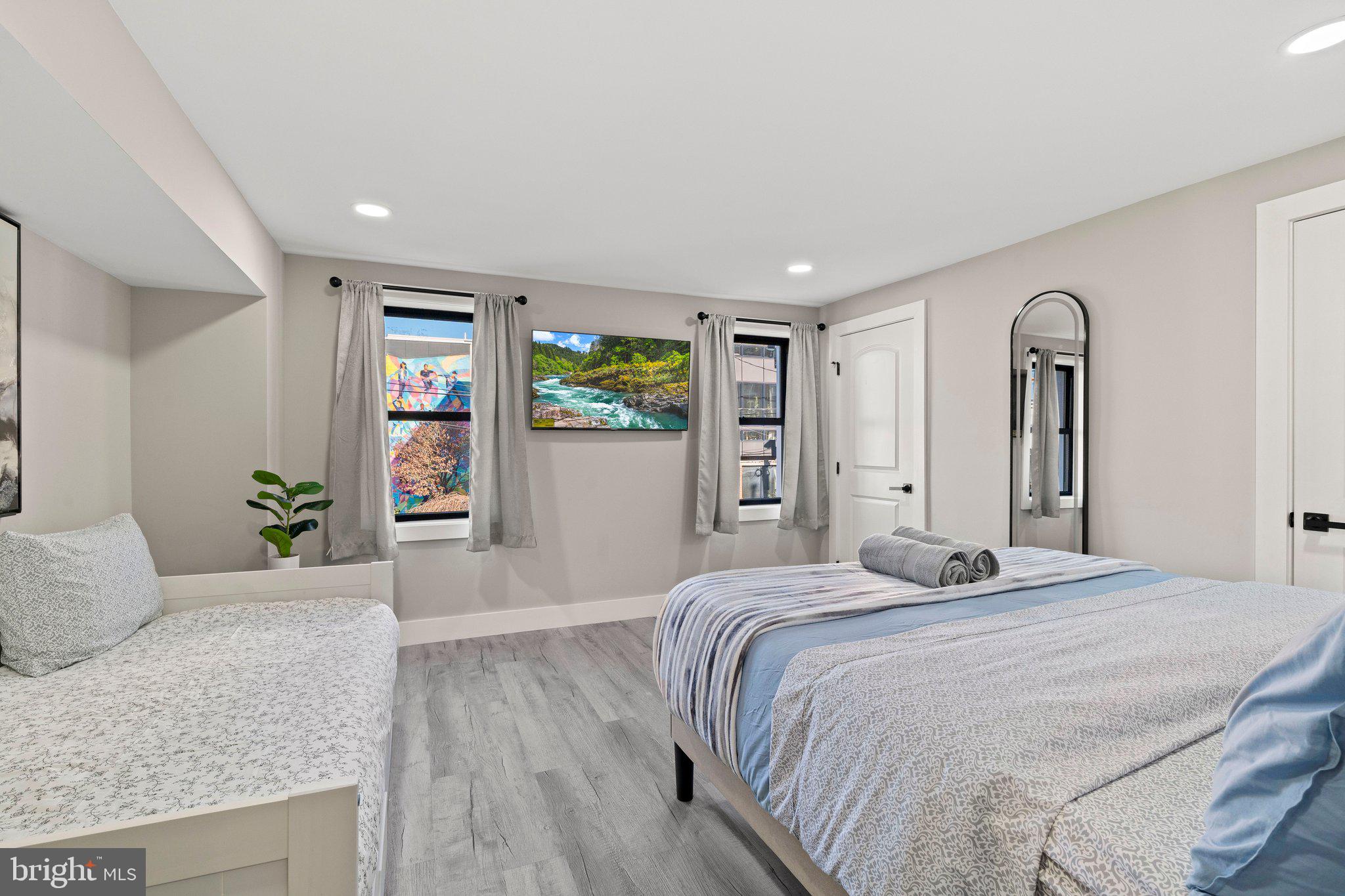 124 Master Street Philadelphia, PA 19122 - Photo 22 of 39 a spacious bedroom with a bed and dresser