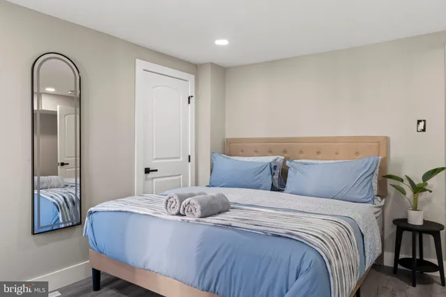 a bedroom with a bed and a painting on the wall