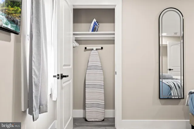 a view of a bedroom with a bed and hallway