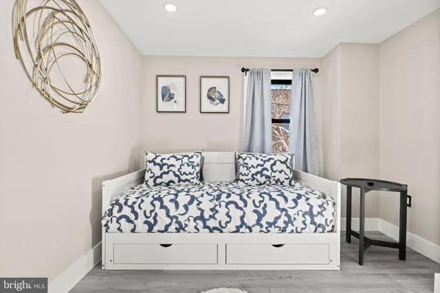 a bedroom with a large bed and a chair