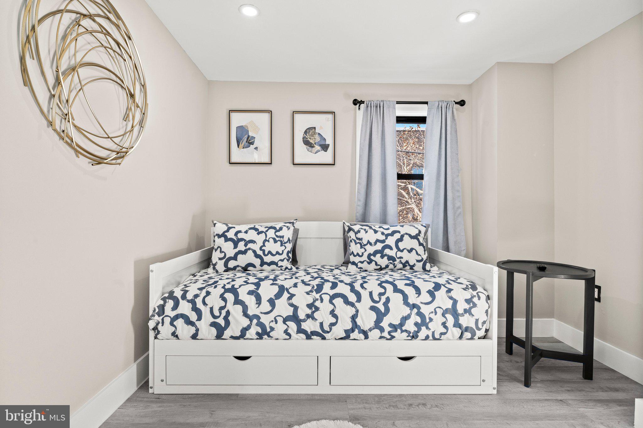 124 Master Street Philadelphia, PA 19122 - Photo 30 of 39 a bedroom with a large bed and a chair