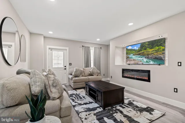 a living room with furniture a rug and a painting