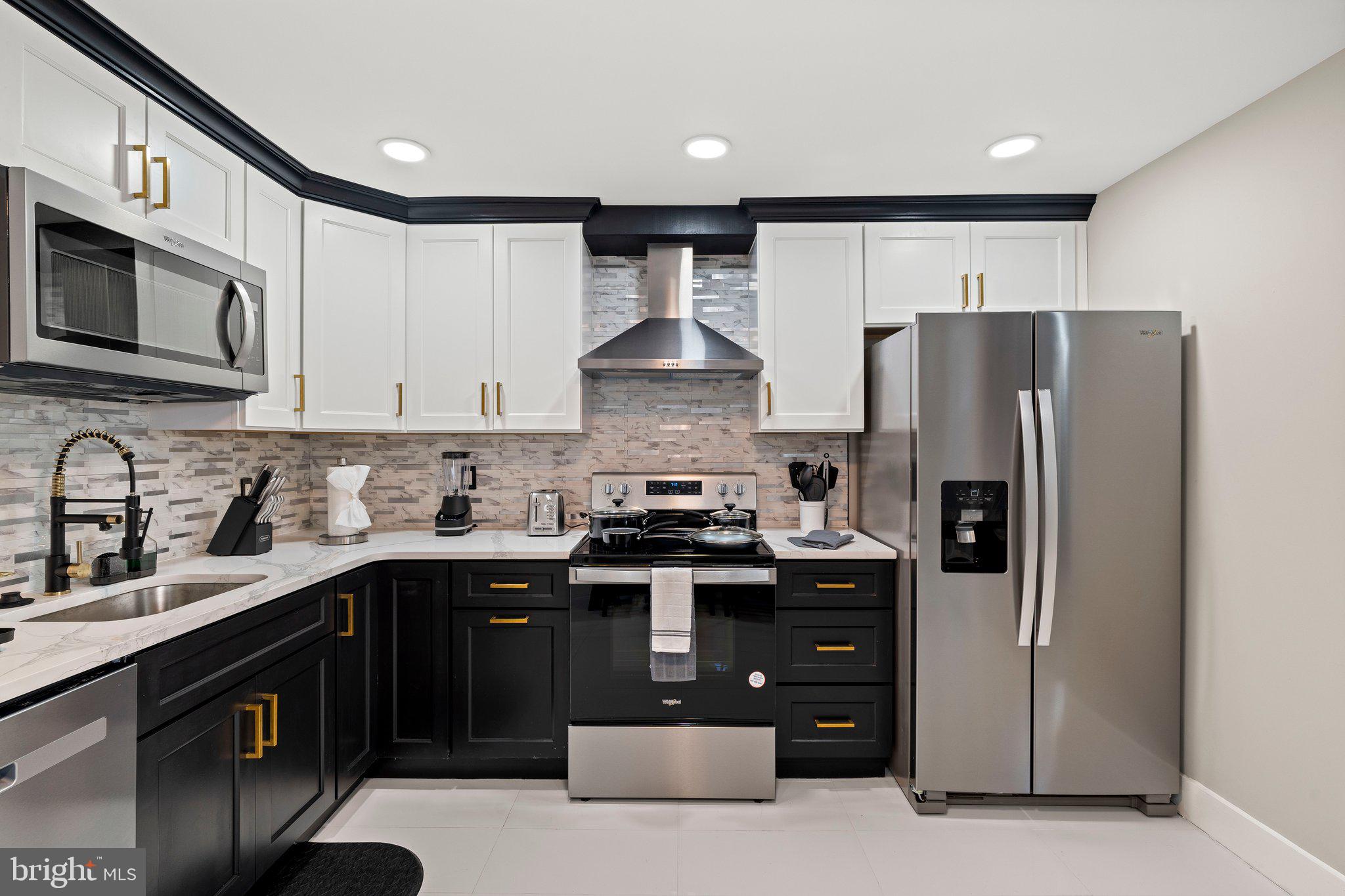 124 Master Street Philadelphia, PA 19122 - Photo 4 of 39 a kitchen with stainless steel appliances granite countertop a stove a refrigerator and a sink