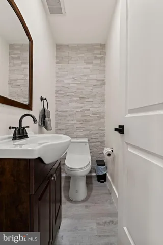 a bathroom with a sink a toilet and mirror