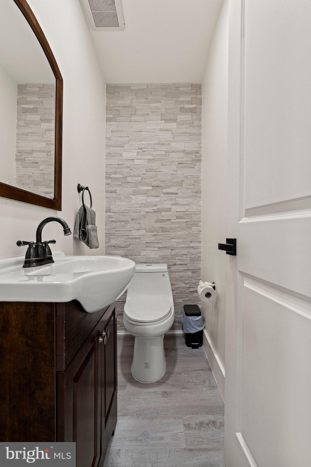 124 Master Street Philadelphia, PA 19122 - Photo 7 of 39 a bathroom with a sink a toilet and mirror