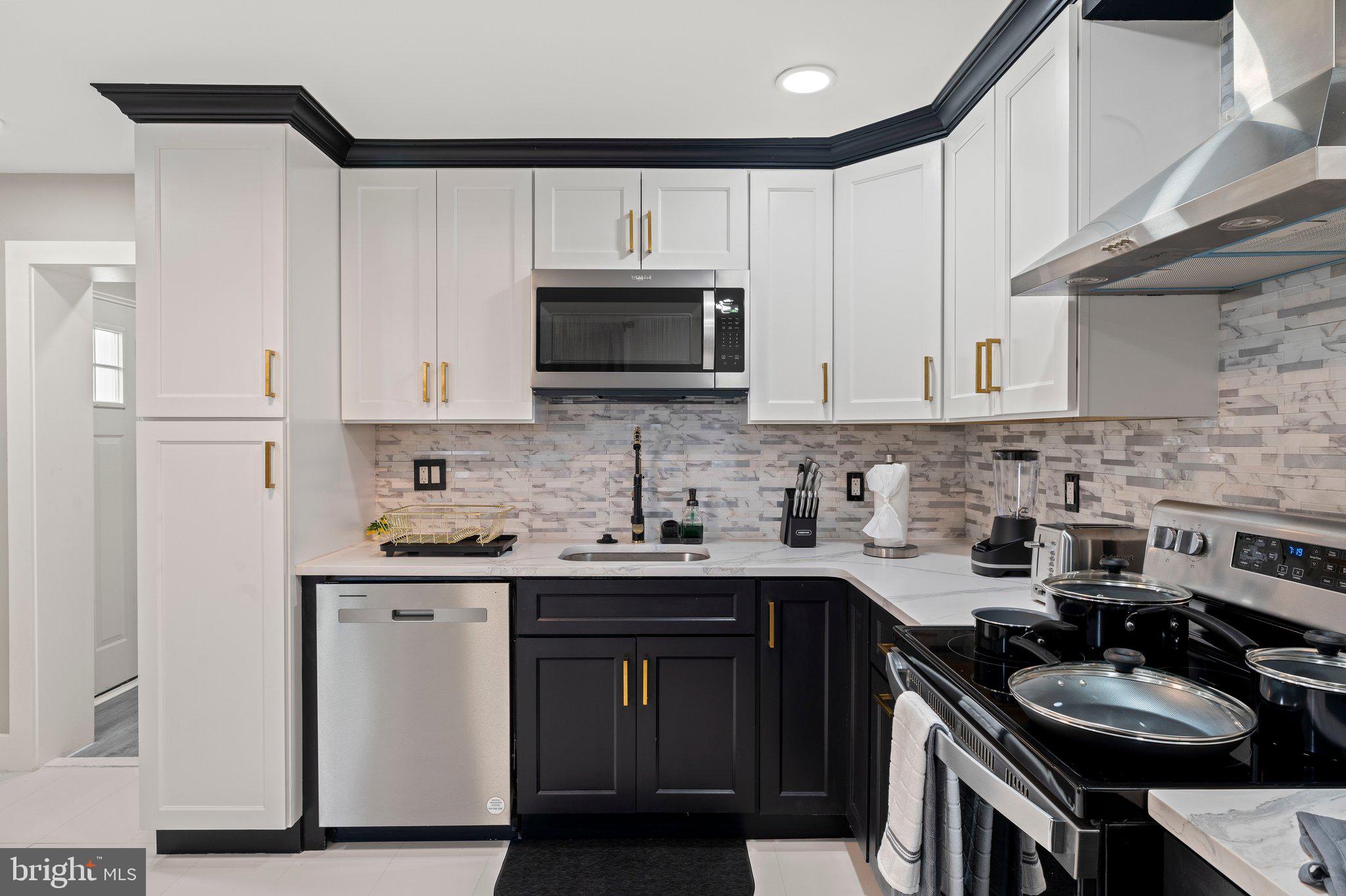 124 Master Street Philadelphia, PA 19122 - Photo 10 of 39 a kitchen with a sink stove and cabinets