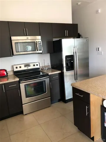 a kitchen with a stove and a refrigerator