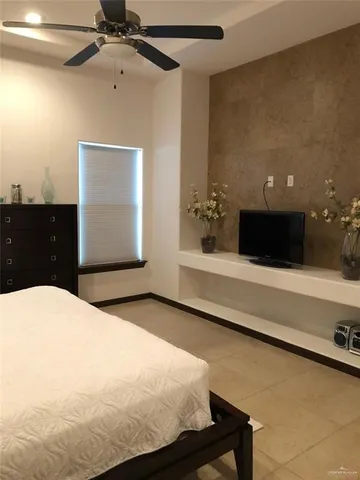 a bedroom with a bed and a night stand