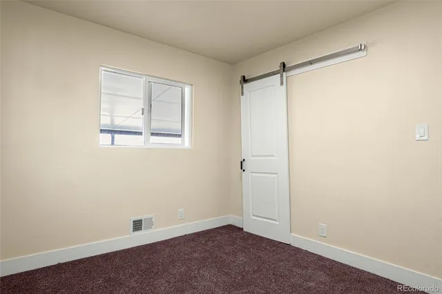 an empty room with a empty space and a window