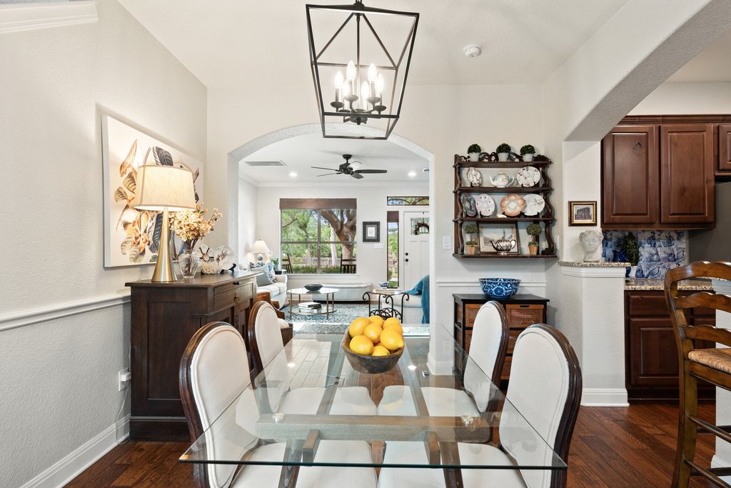 6708 Menchaca Road, Unit 2 Austin, TX 78745 - Photo 12 of 30 Dining area featuring wood-finish flooring, a contemporary black metal chandelier, and an arched doorway
