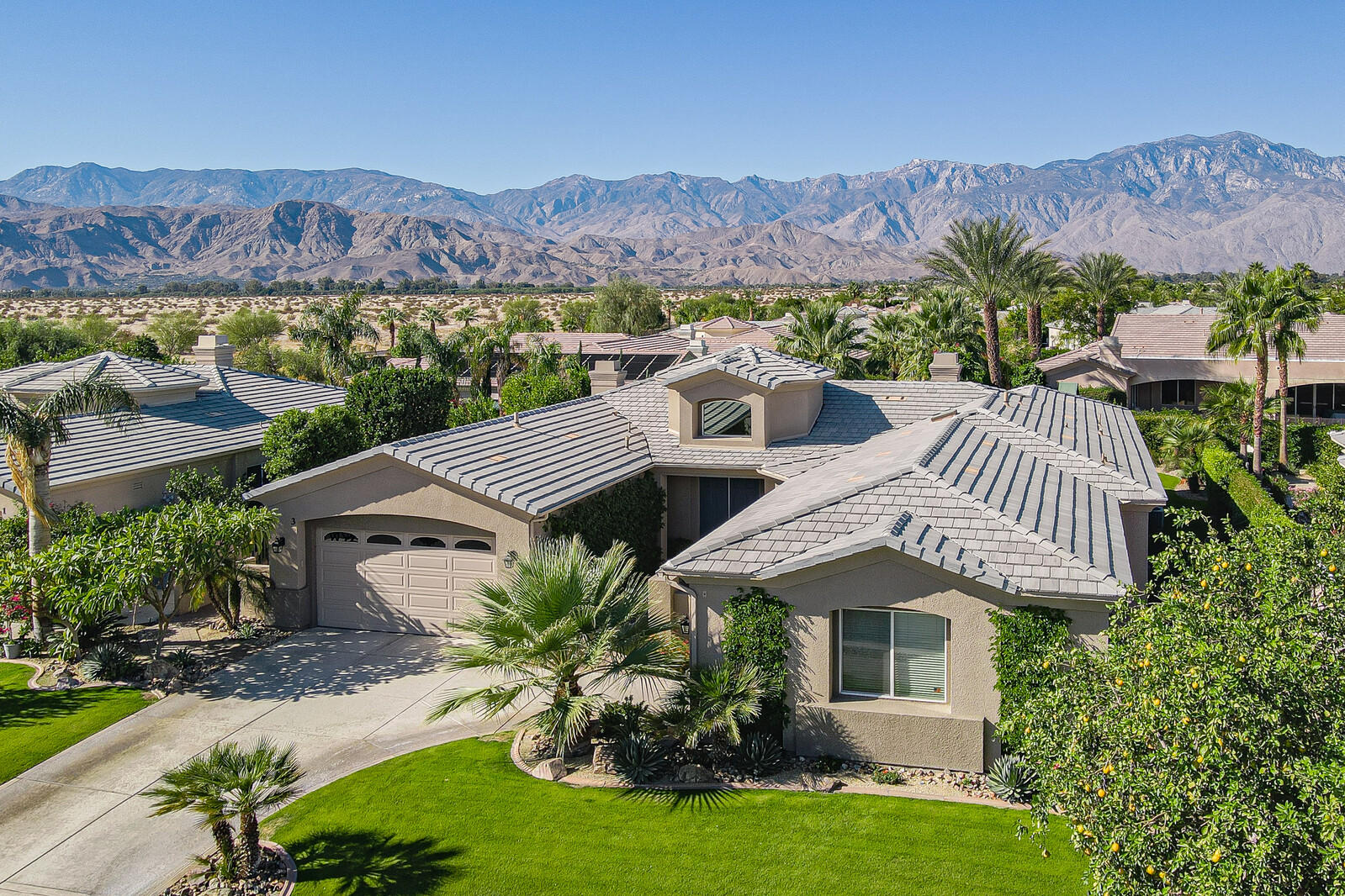 3 Lyon Road Rancho Mirage, CA 92270 - Photo 1 of 38 a front view of a house with a yard and a garden