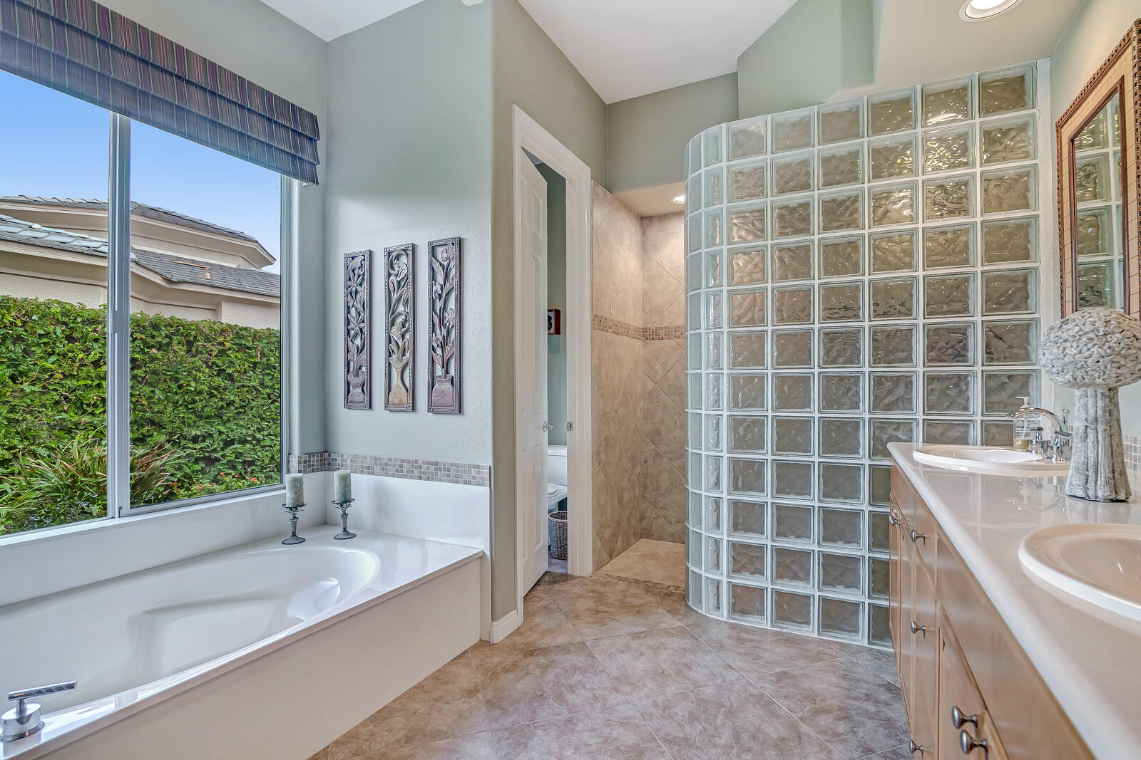 3 Lyon Road Rancho Mirage, CA 92270 - Photo 18 of 38 a bathroom with a tub a sink a window and a shower