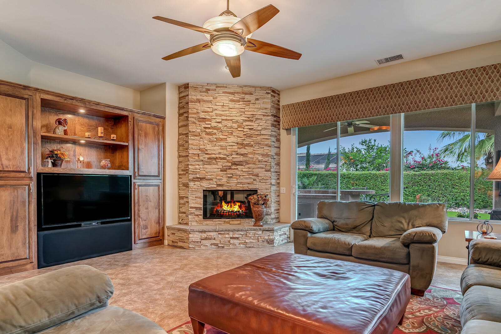 3 Lyon Road Rancho Mirage, CA 92270 - Photo 4 of 38 a living room with furniture a flat screen tv and a fireplace