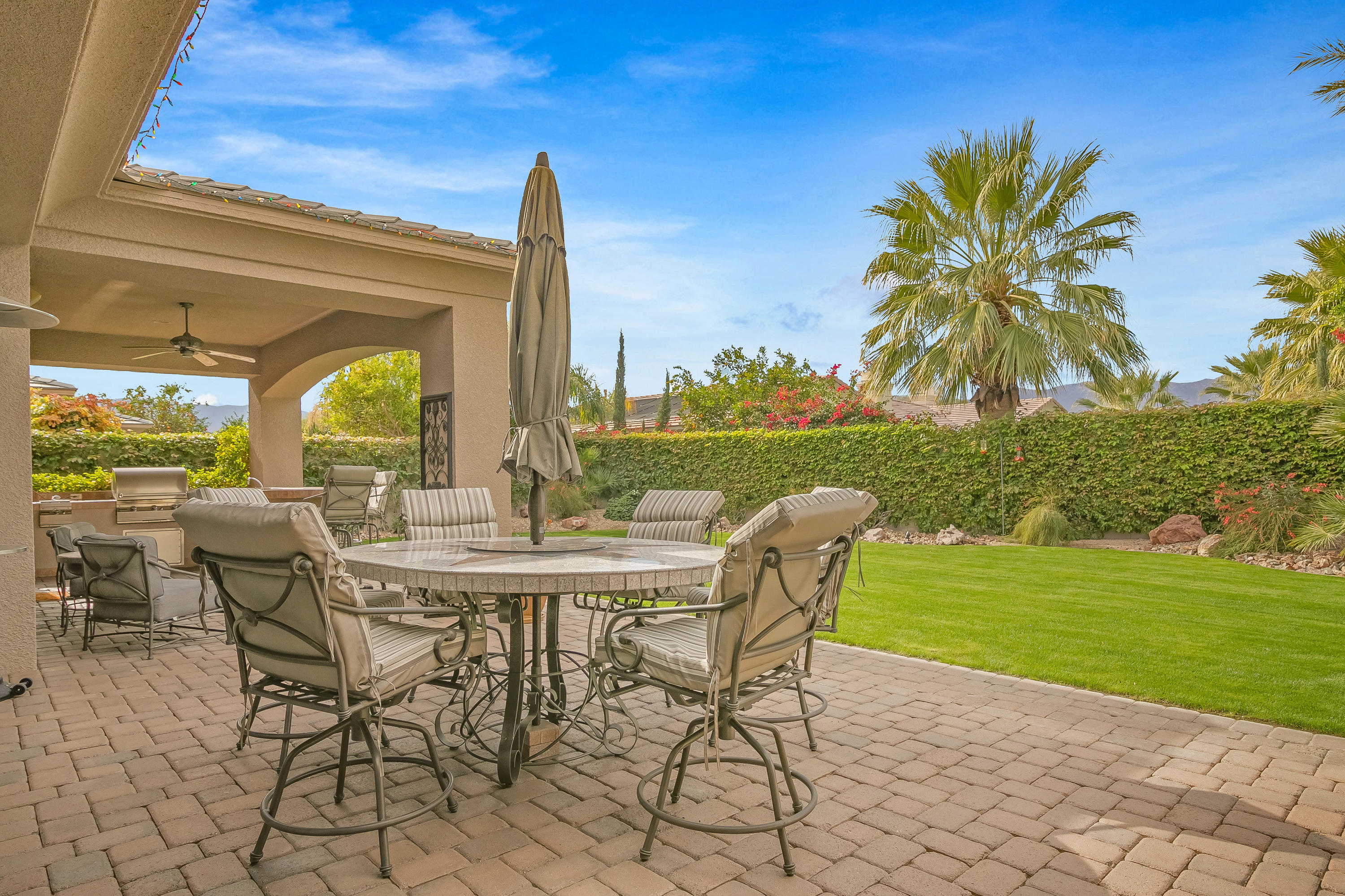 3 Lyon Road Rancho Mirage, CA 92270 - Photo 38 of 38 a view of a patio with a table chairs and a garden