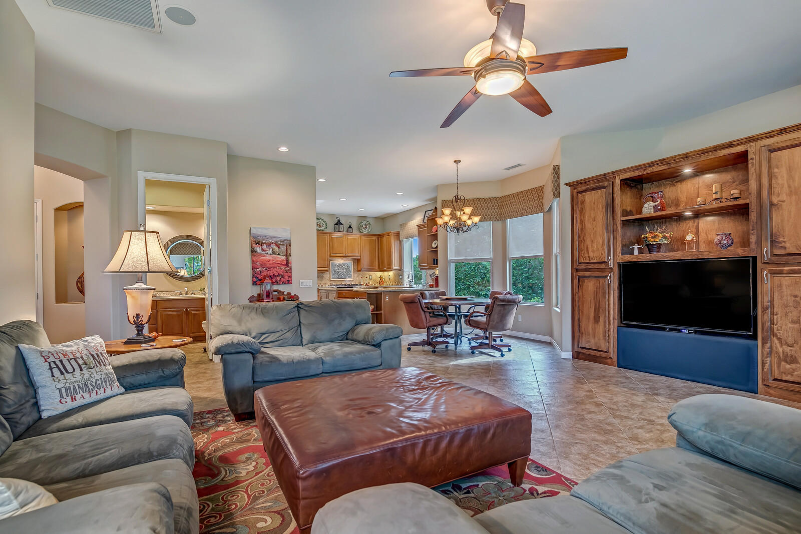 3 Lyon Road Rancho Mirage, CA 92270 - Photo 6 of 38 a living room with furniture a flat screen tv and a large window