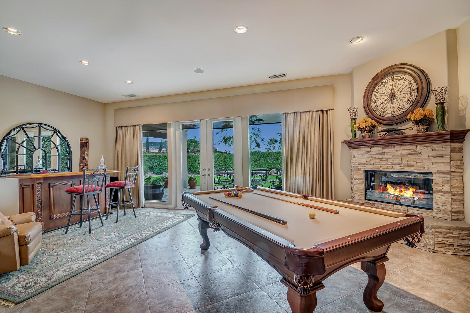 3 Lyon Road Rancho Mirage, CA 92270 - Photo 7 of 38 a living room with fireplace furniture and a large window