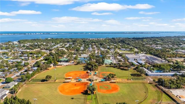 an aerial view of a residential houses with outdoor space