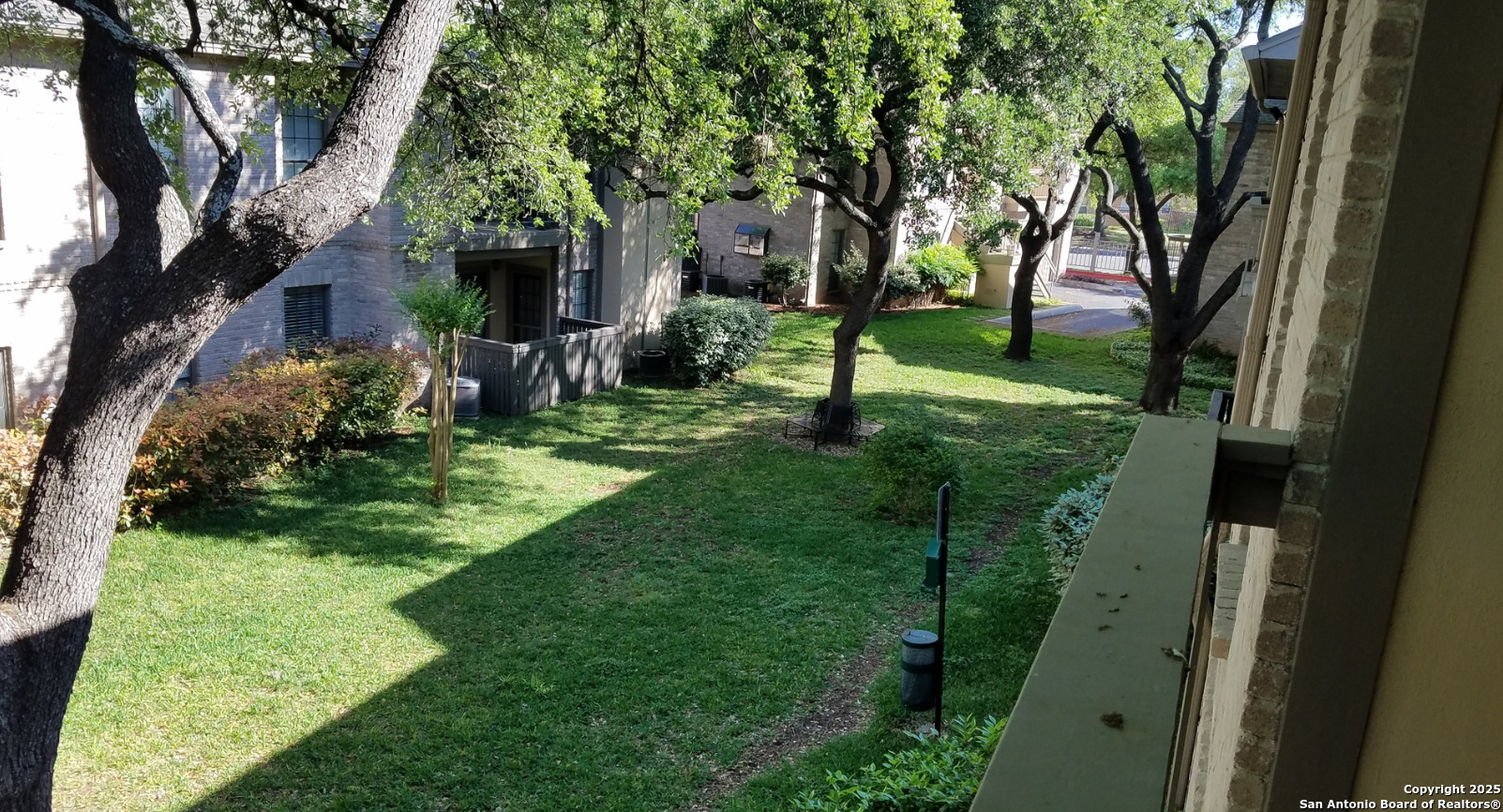11839 Parliament Drive, Unit 1921 San Antonio, TX 78216 - Photo 17 of 19 a view of a backyard with large trees