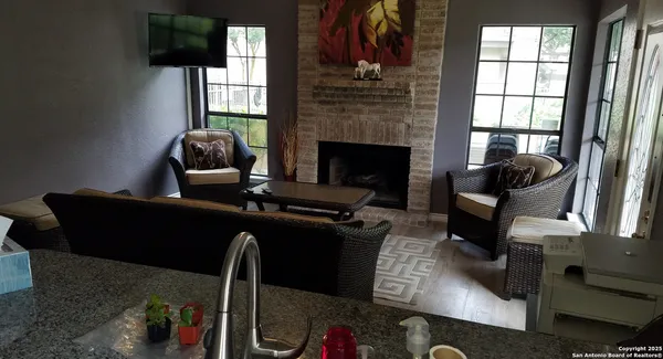a living room with furniture rug and window
