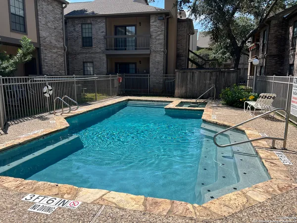 a view of swimming pool with patio