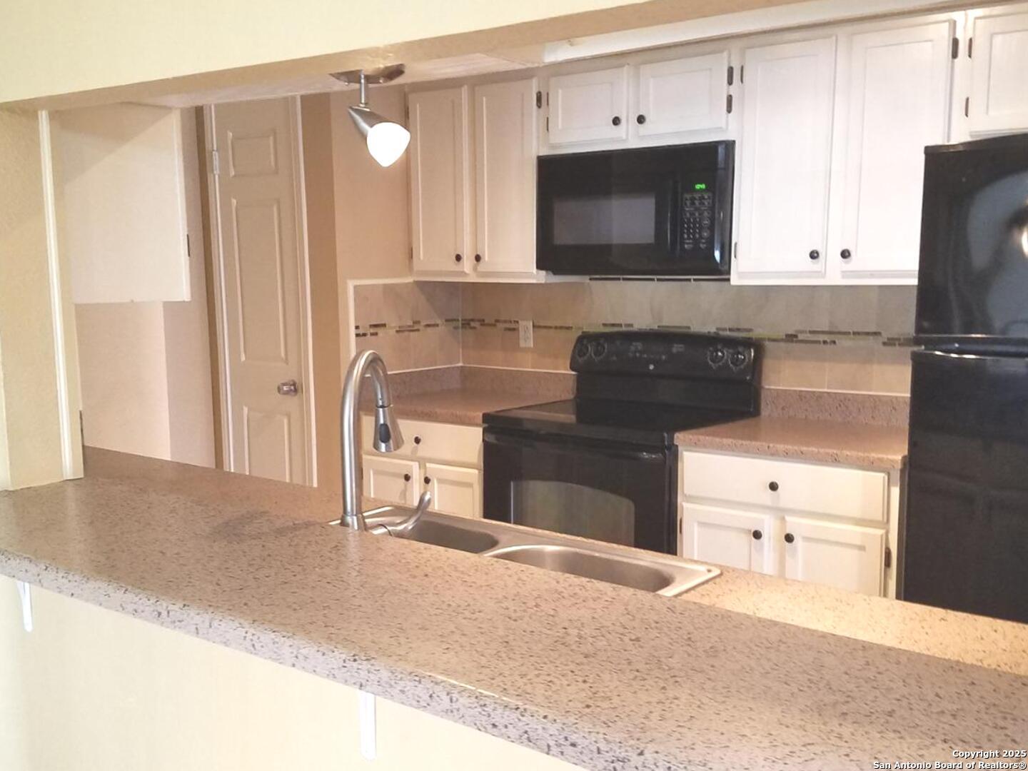 11839 Parliament Drive, Unit 1921 San Antonio, TX 78216 - Photo 8 of 19 a kitchen with stainless steel appliances white cabinets and stove