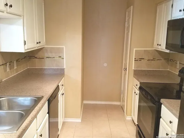 a kitchen with a sink and a refrigerator