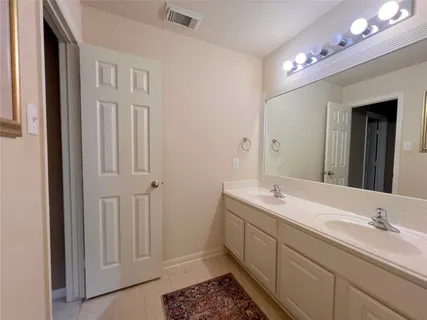 a bathroom with a double vanity sink mirror and double