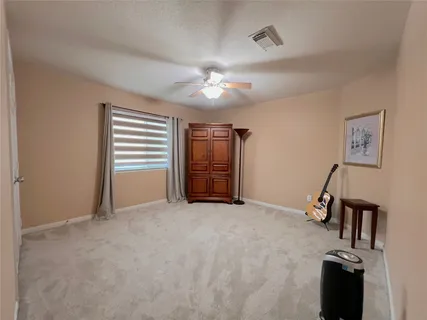 a living room with couches floor to ceiling window with wooden floor