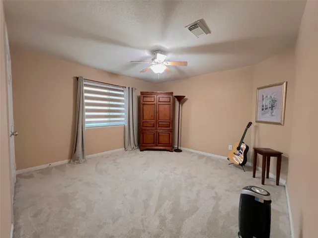 a living room with couches floor to ceiling window with wooden floor