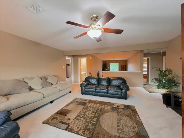 a view of a swimming pool with red chairs