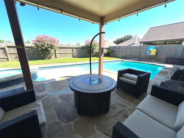 an aerial view of a house with a garden and trees