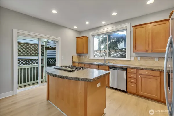 a kitchen with sink a window and cabinets