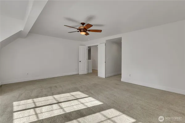 a view of room with a ceiling fan and window