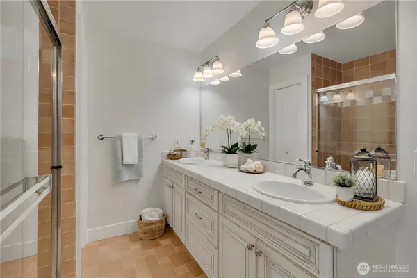 a bathroom with a sink a light fixture and a mirror