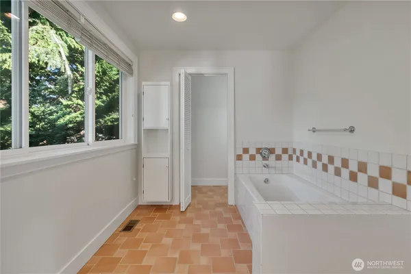 a bathroom with a tub and a window