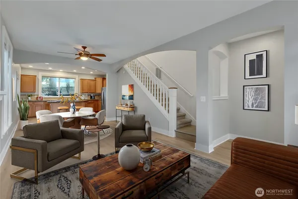 a living room with furniture ceiling fan and a rug