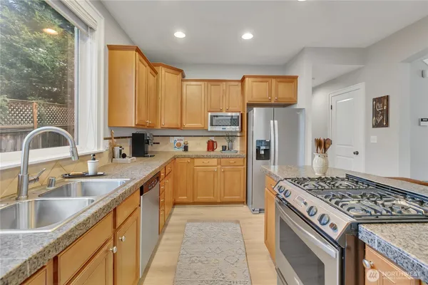 a kitchen with a sink stove and refrigerator