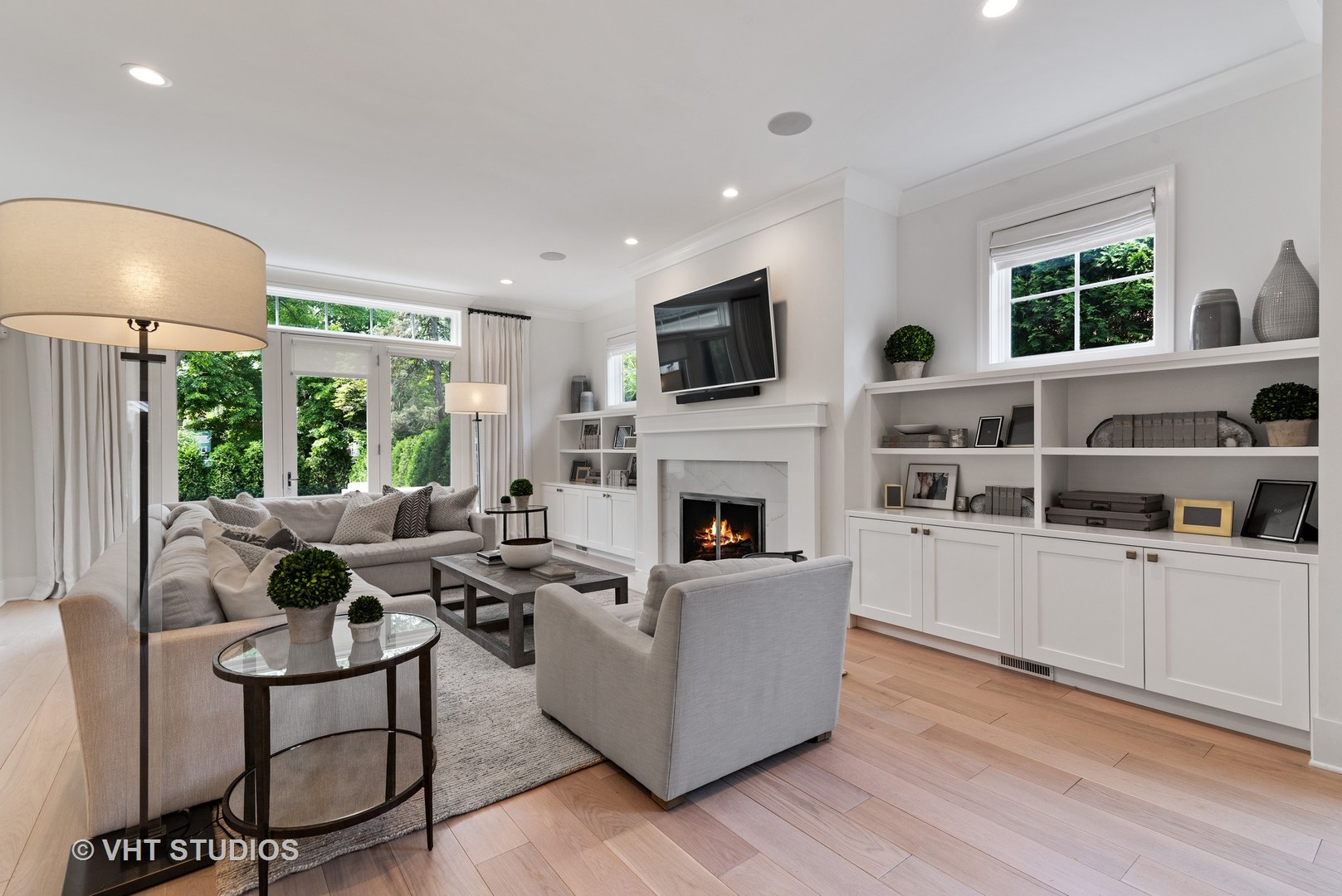 300 Greenleaf Avenue Wilmette, IL 60091 - Photo 11 of 43 a living room with furniture a fireplace and a flat screen tv